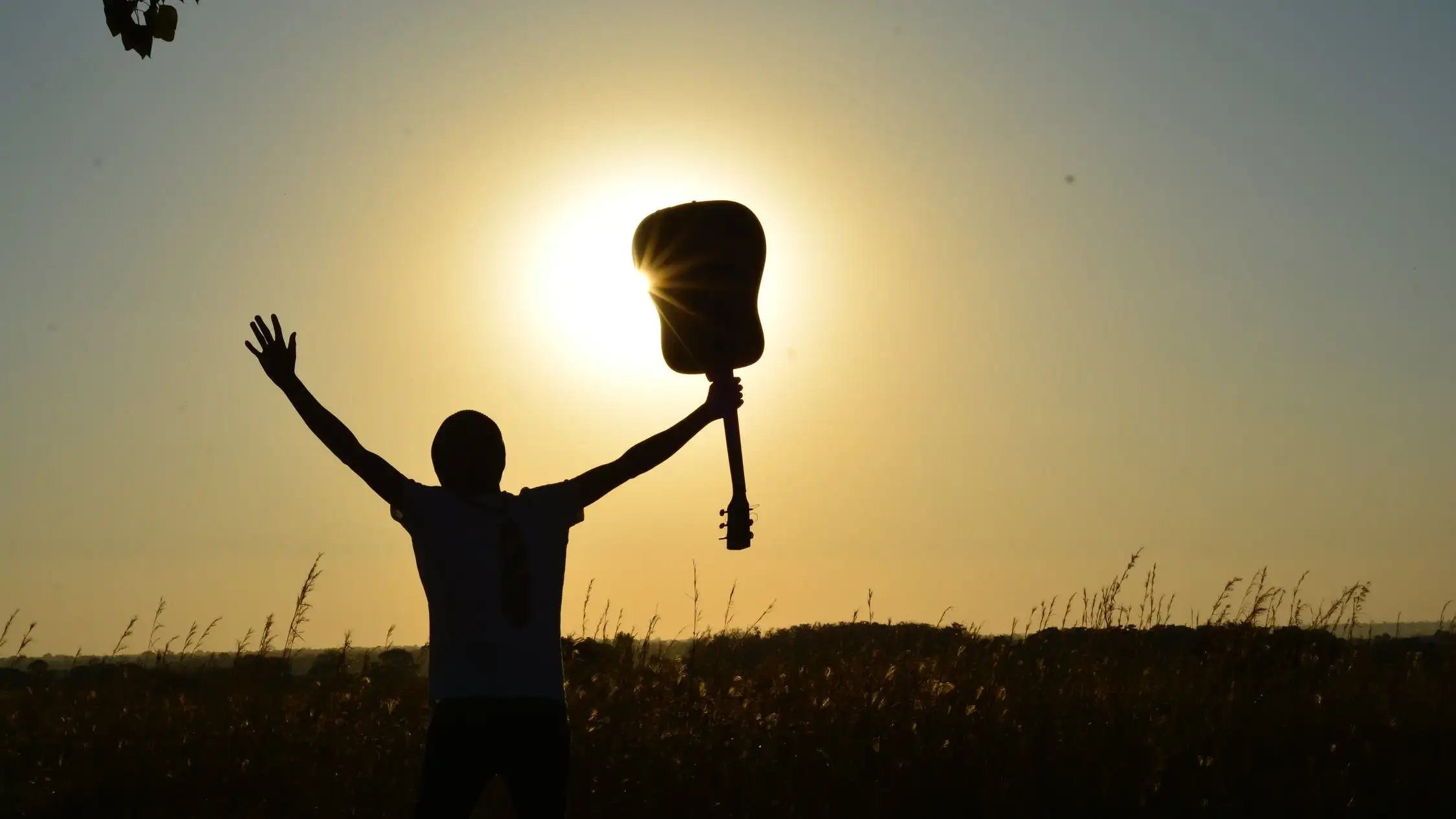 person with guitar outdoors